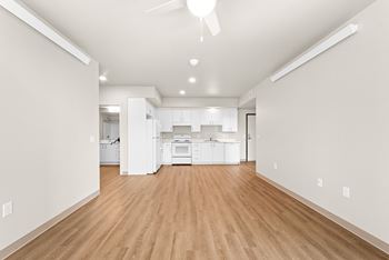Spacious kitchen view with wooden floor